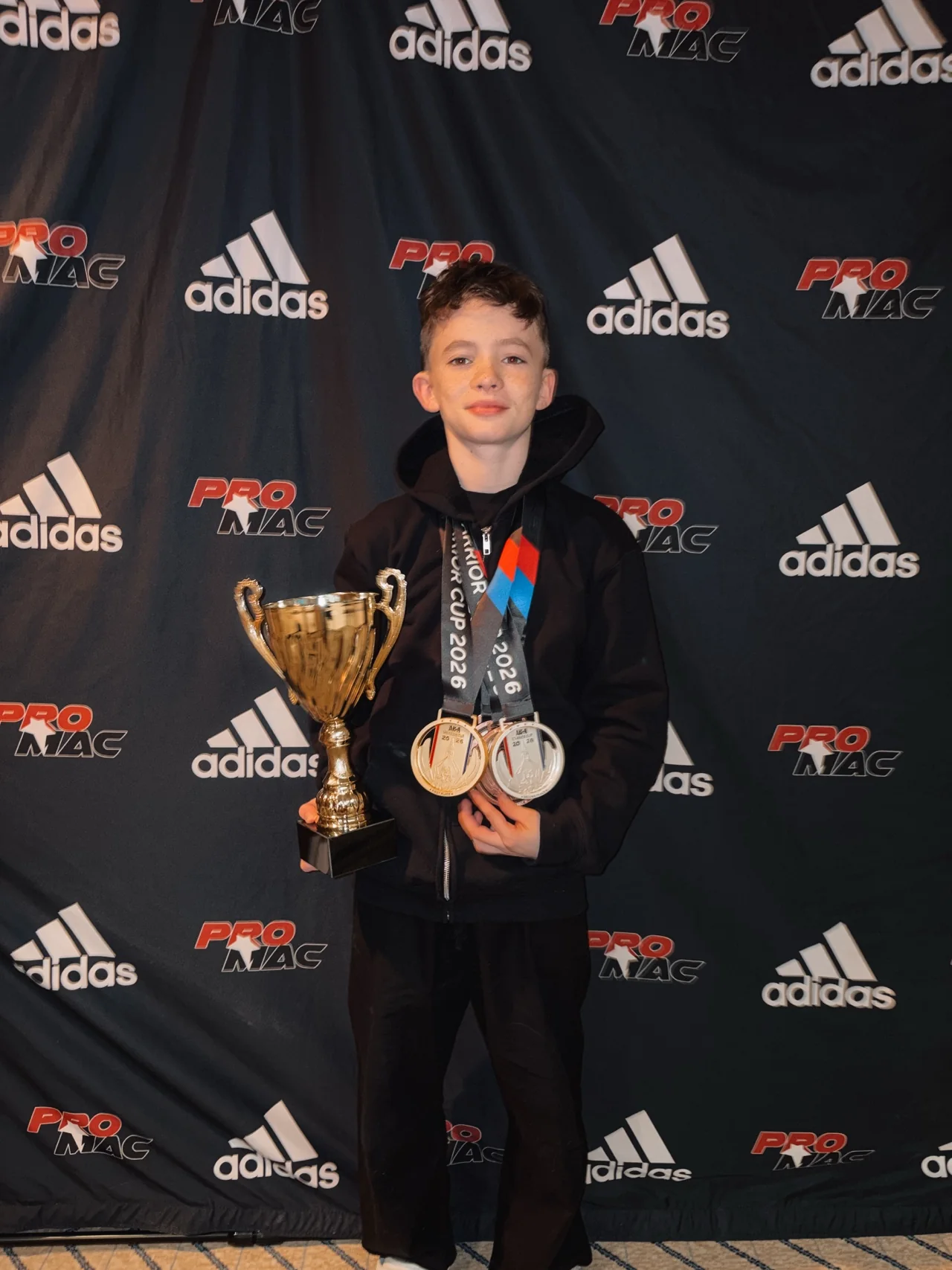 Parker with a trophy and medals after competition